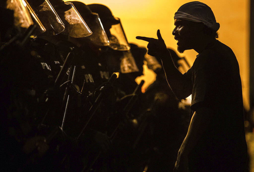 A protester vents at a line of Tucson Police Officers in riot gear at Cushing Street and Church ...