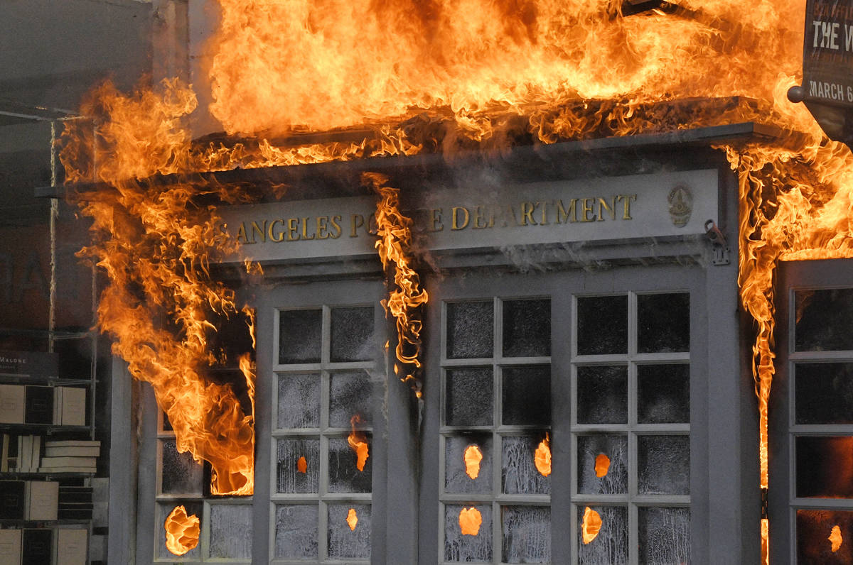 A Los Angeles Police Department kiosk is seen ablaze in The Grove shopping center during a prot ...