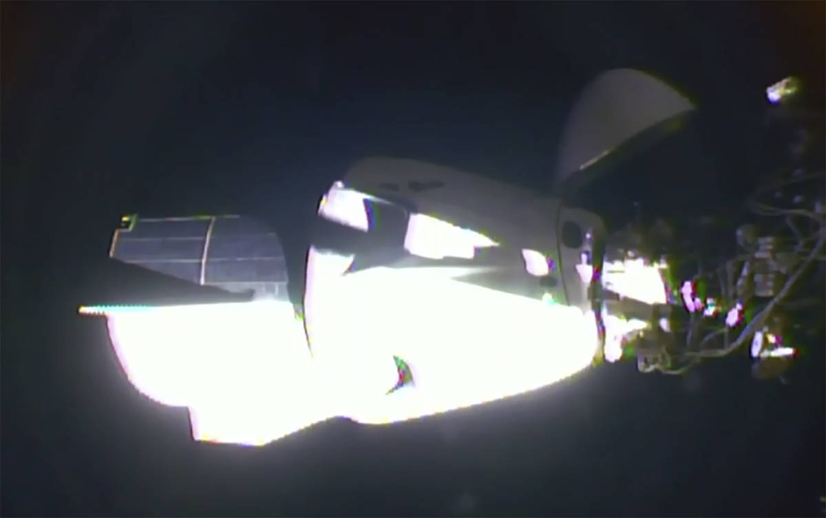 In this image taken from NASA TV video, the SpaceX Dragon crew capsule, with NASA astronauts Do ...