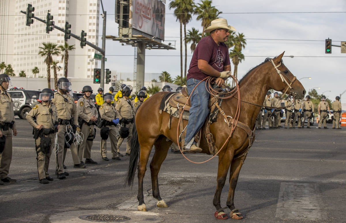 A cowboy joins police during a Black Lives Matter protest on the Las Vegas Strip on Sunday, May ...