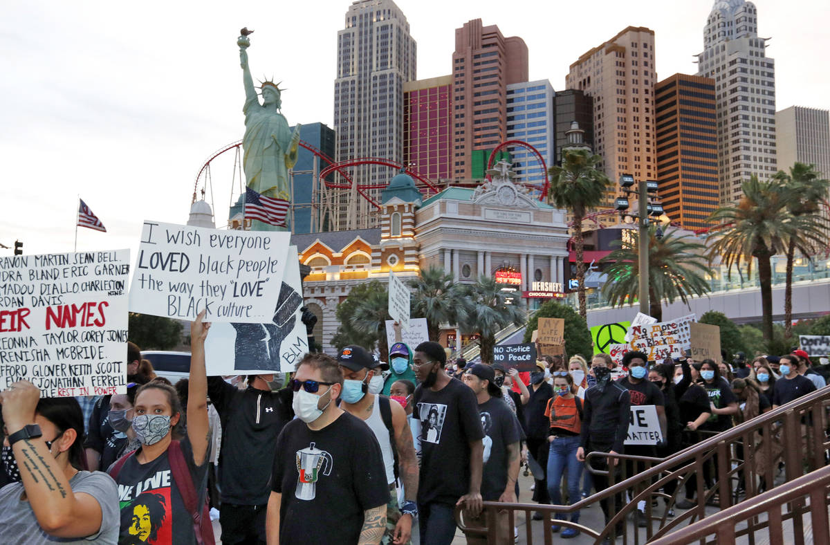 People march along the Las Vegas Strip, Sunday, May, 31, 2020, during a protest over the death ...