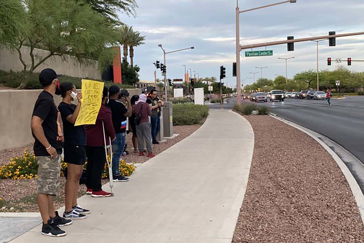 Black Lives Matter protesters stand outside Downtown Summerlin, Sunday, May 31, 2020. (Mick Ake ...