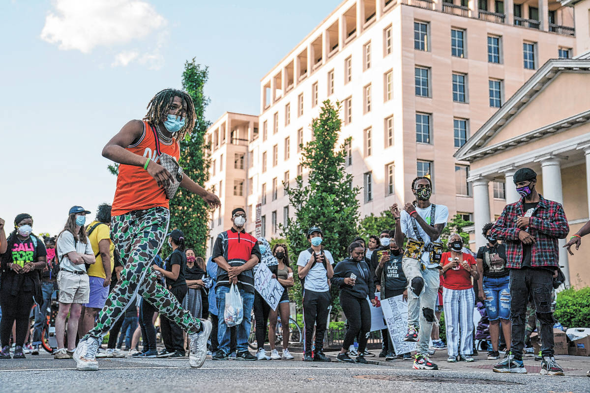 A group of dancers perform during a protest over the death of George Floyd, Sunday, May 31, 202 ...