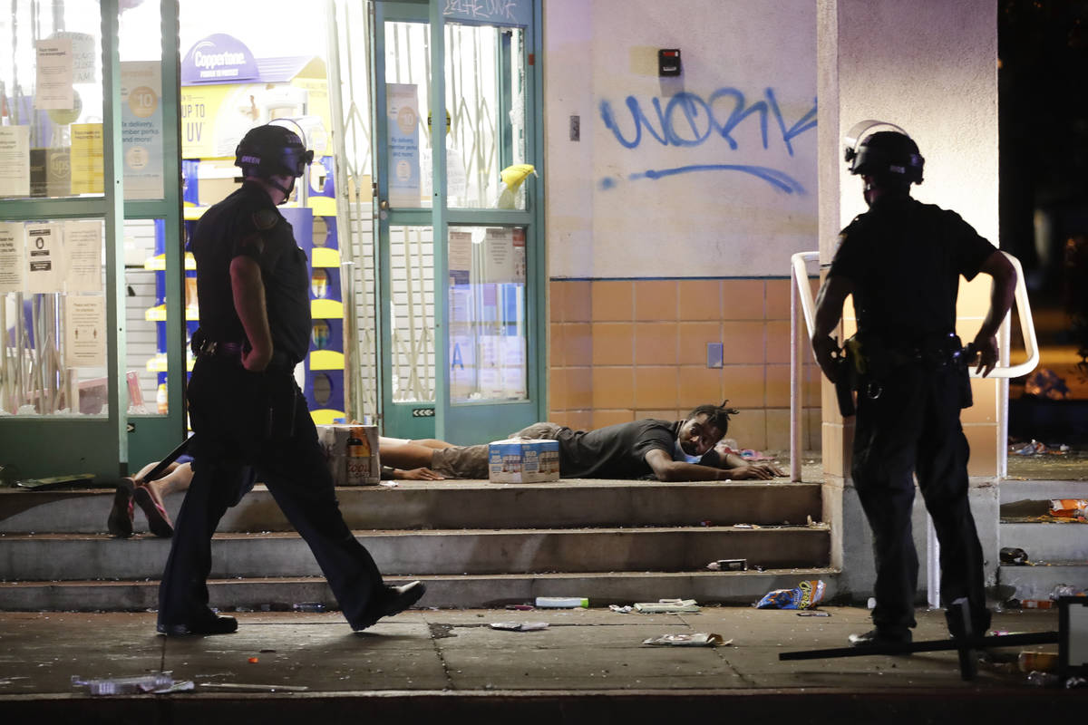A man is arrested outside a CVS store Sunday, May 31, 2020, in Santa Monica, Calif., during unr ...