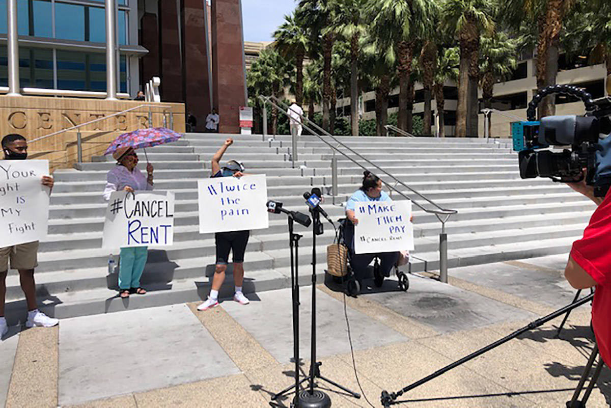 Eight people, some wearing Make The Road Nevada T-shirts, stood outside the Regional Justice Ce ...