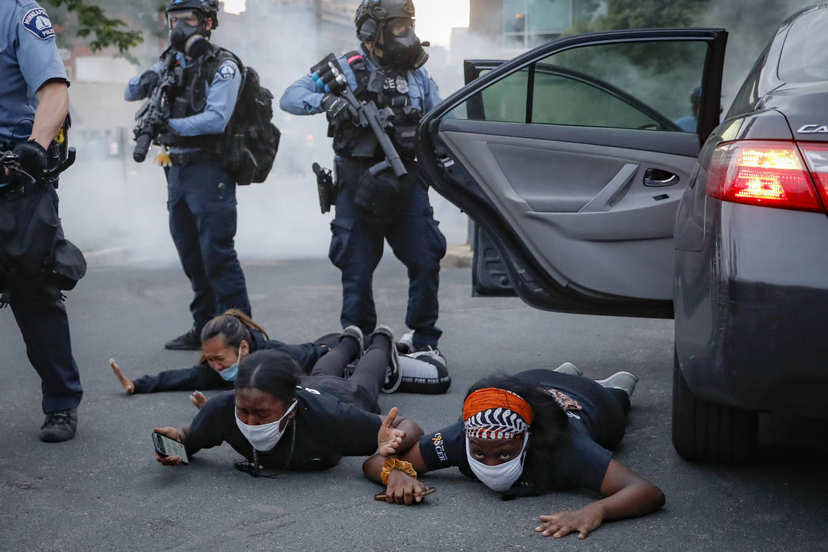 Motorists are ordered to the ground from their vehicle by police during a protest on South Wash ...