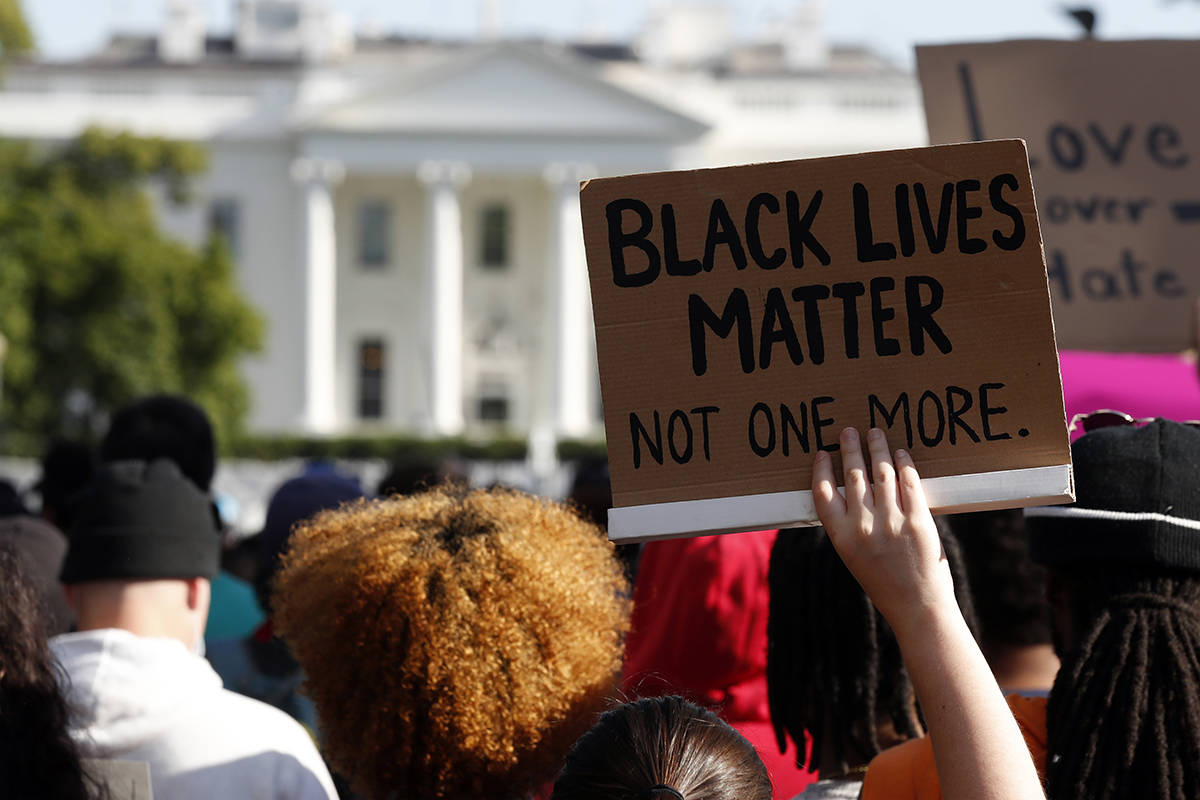 Demonstrators gather to protest the death of George Floyd, Sunday, May 31, 2020, near the White ...