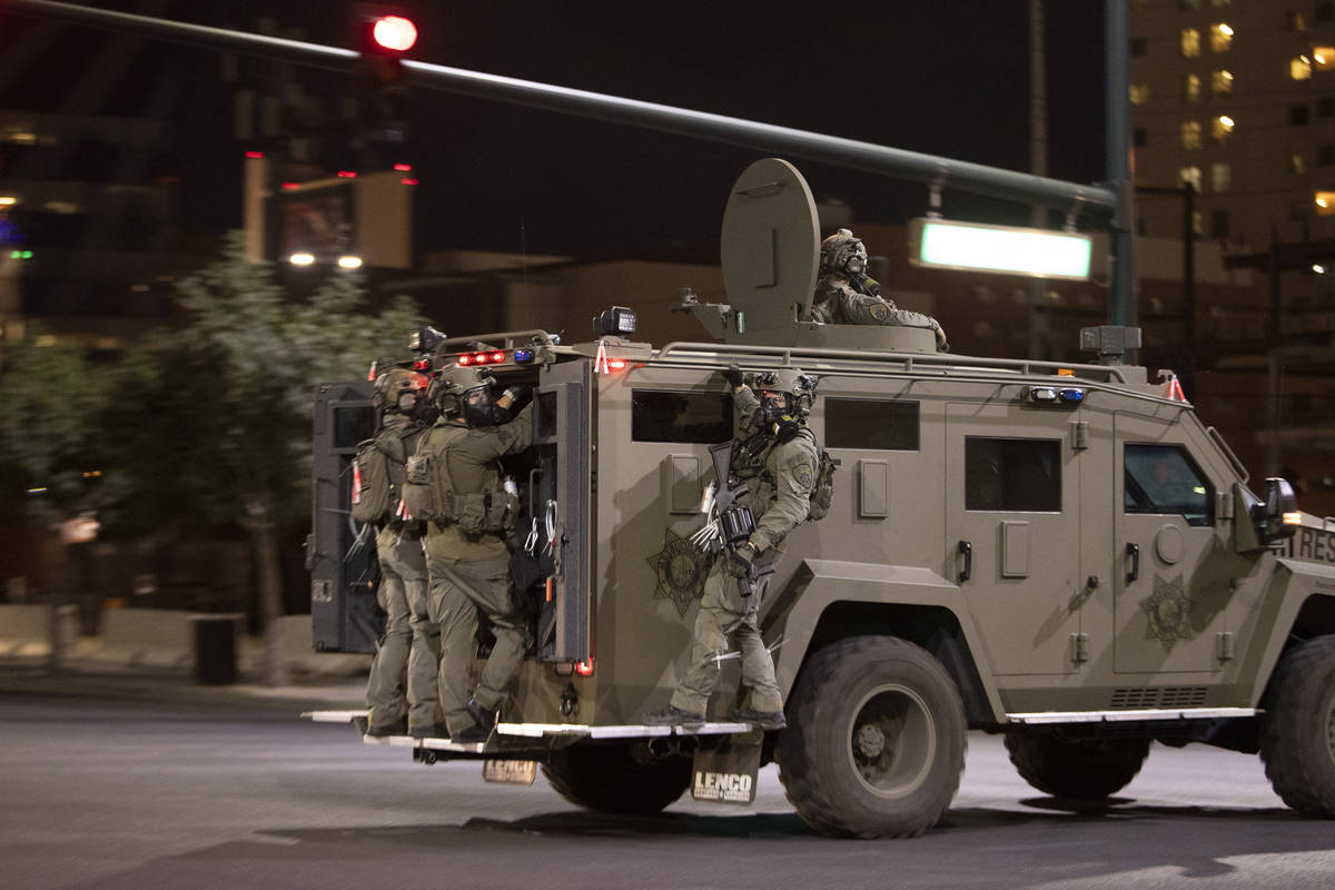 Metropolitan police make their way into downtown as protesters moved from the Strip to Fremont ...