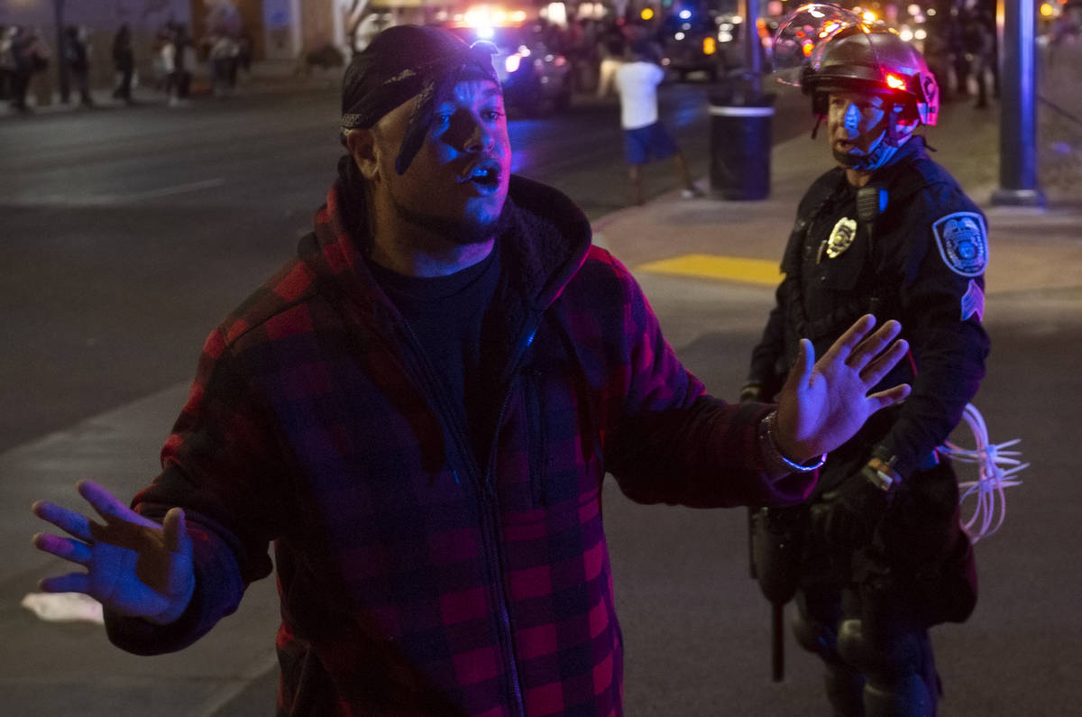 A protester argues with police during an event organized by Black Lives Matter in downtown Las ...