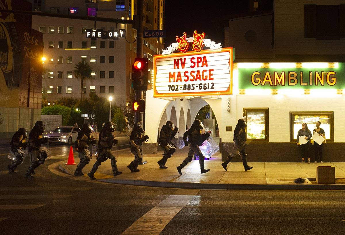 Police race down Fremont Street during a protest organized by Black Lives Matter in downtown La ...