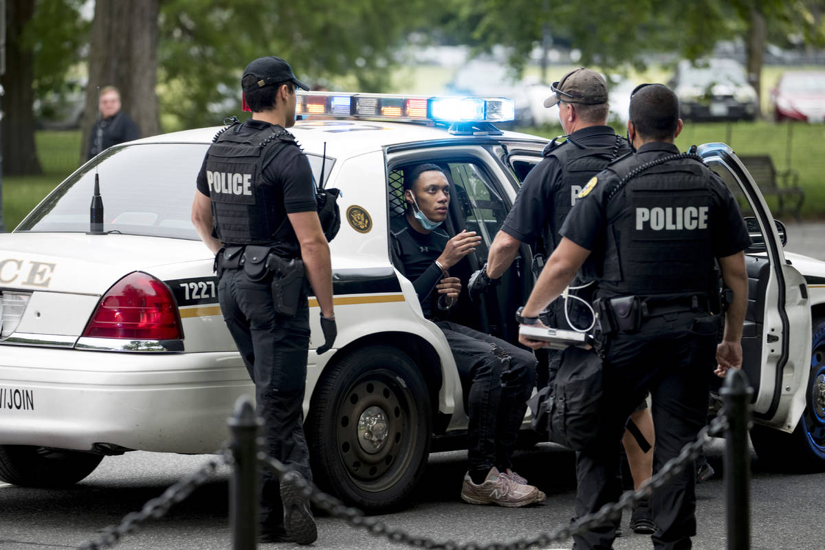 U.S. Secret Service police arrest a man for what one eye witness said an officer told him was f ...