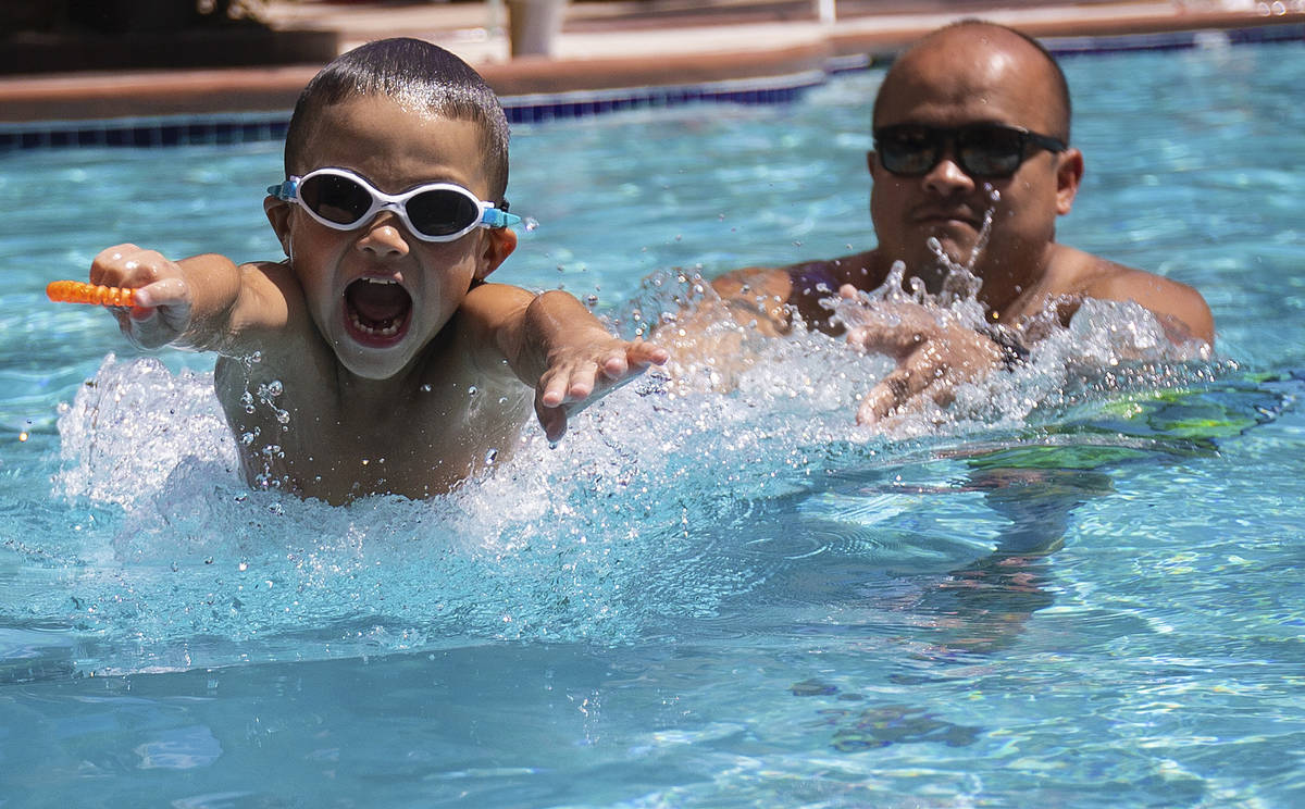 Sergio Gurrola Jr., 6, from Bakersfield, Calif., practices swimming with father Sergio Gurrola ...
