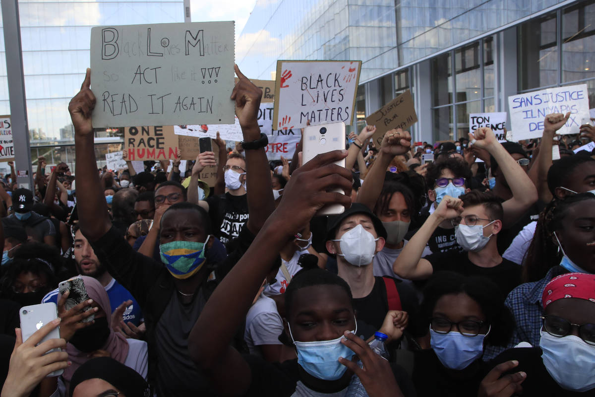 People protest outside the Palace of Justice Tuesday, June 2, 2020 in Paris. French authorities ...