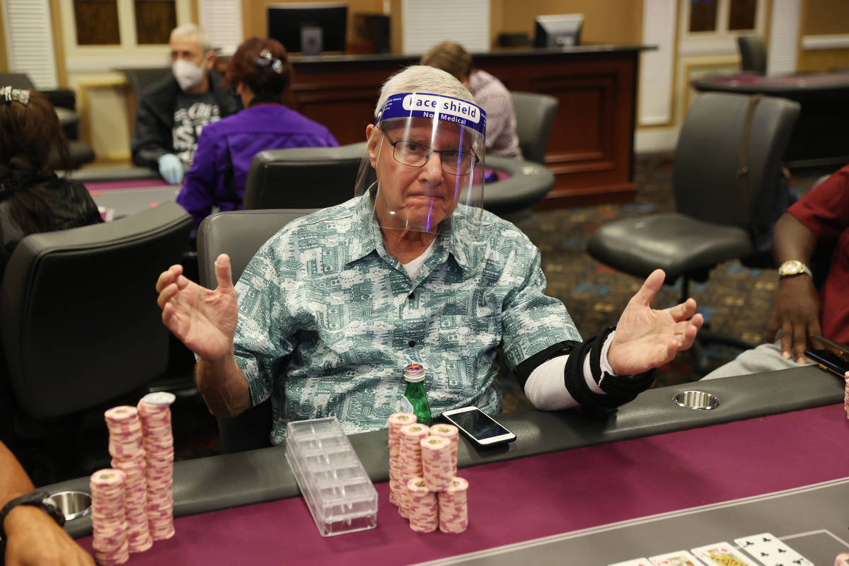 Dr. Jeff of Las Vegas, who declined to give a last name, plays poker wearing a face shield at T ...