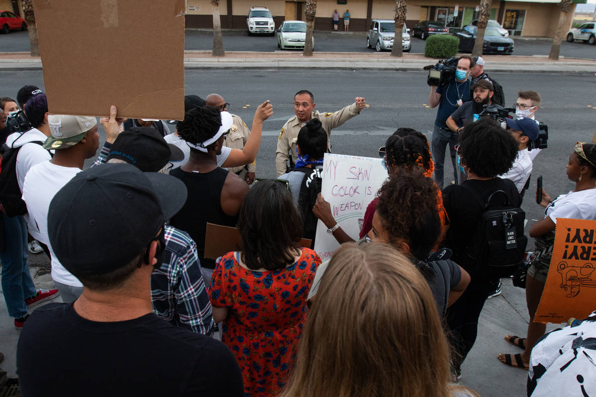 Protesters tell Las Vegas police officers where they intend to go during a Black Lives Matter p ...
