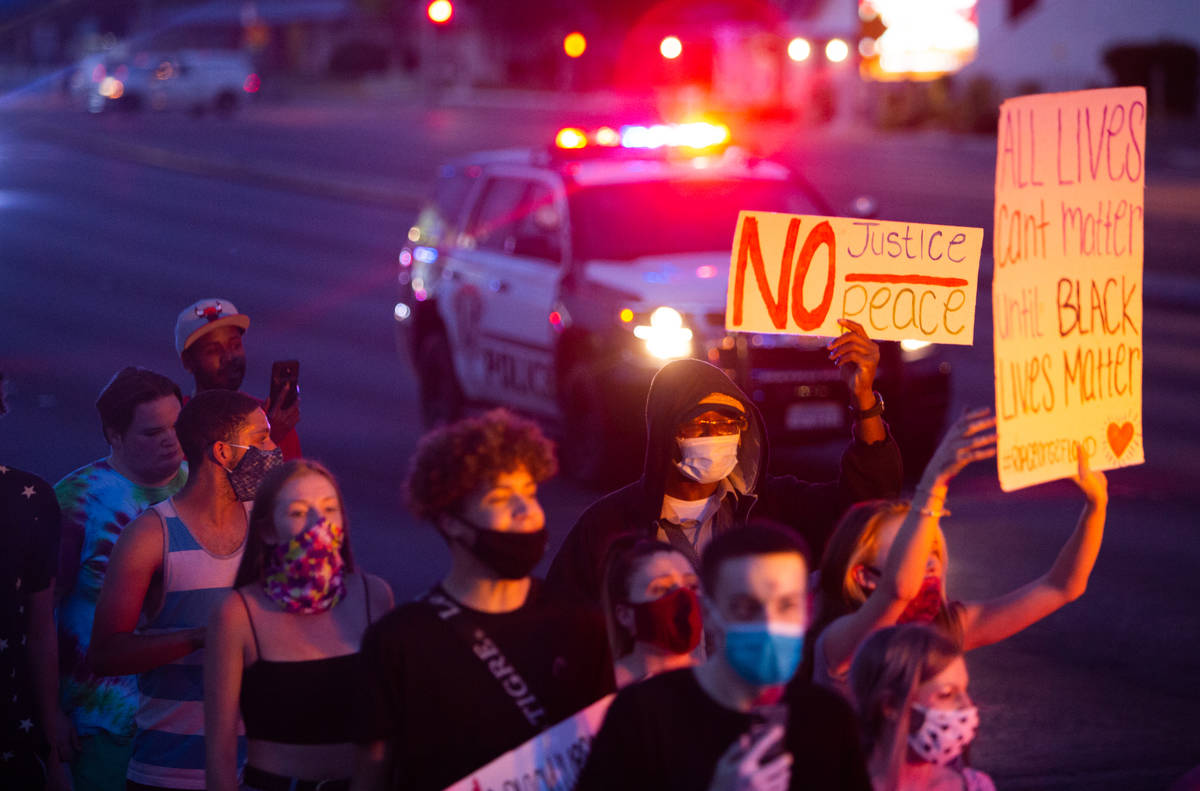Protesters march as police escort them during a Black Lives Matter protest at UNLV in Las Vegas ...