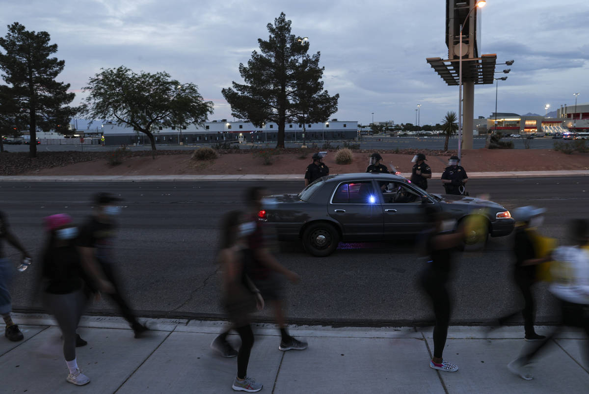 Police watch as people march during a Black Lives Matter protest near UNLV in Las Vegas on Tues ...