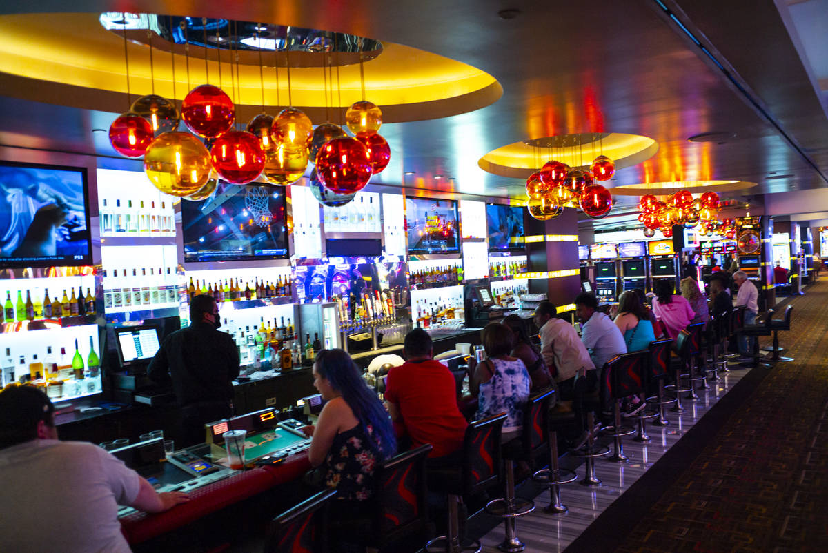 People drink and play bartop gaming machines at the Golden Nugget as hotel-casinos reopen in do ...