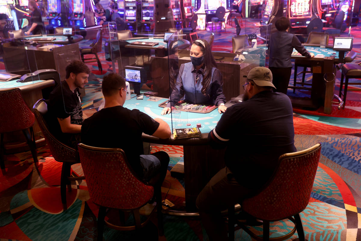 Guests play blackjack at the Bellagio on the Las Vegas Strip as the resort reopens after a 78-d ...