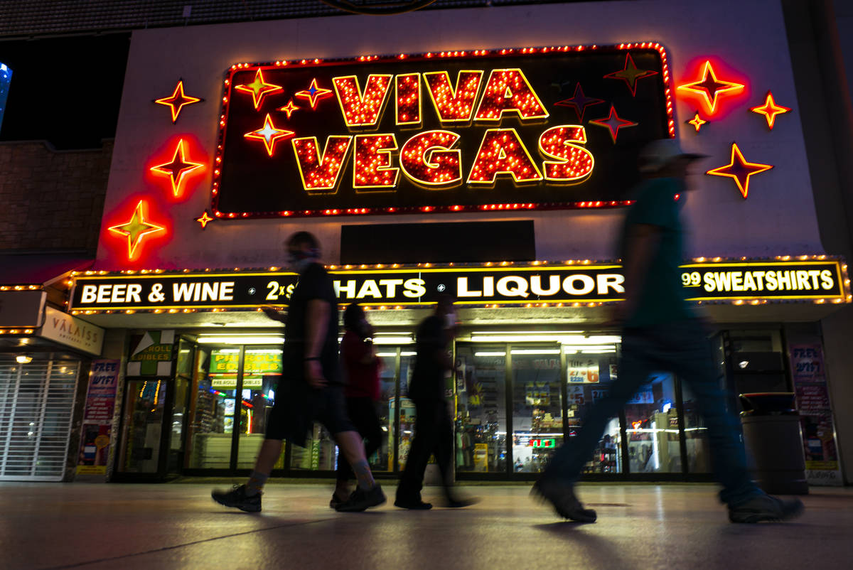People walk past the Viva Vegas gift shop at the Fremont Street Experience as hotel-casinos reo ...
