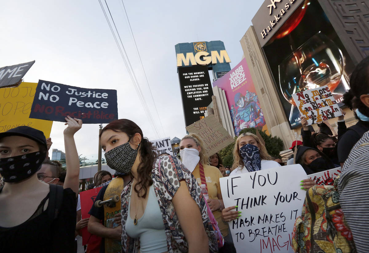 People march around the Las Vegas Strip, Sunday, May, 31, 2020, during a protest over the death ...