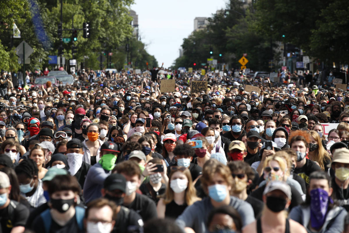 Demonstrators pause to kneel as they march to protest the death of George Floyd, Tuesday, June ...