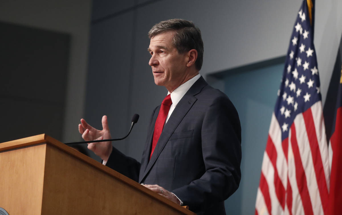North Carolina Gov. Roy Cooper speaks during a briefing at the Emergency Operations Center in R ...