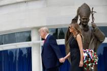 President Donald Trump holds first lady Melania Trump's hand as they visit Saint John Paul II N ...
