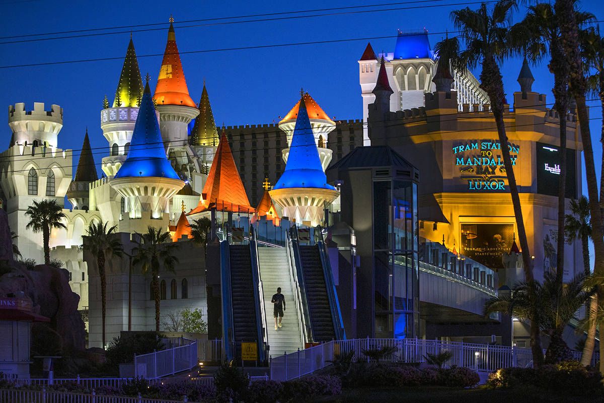 A pedestrian walks down from the bridge across from the Excalibur at Las Vegas Boulevard on the ...