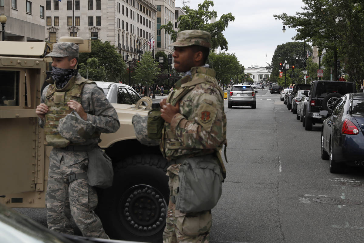 Members of the DC National Guard block an intersection on 16th Street as demonstrators gather t ...