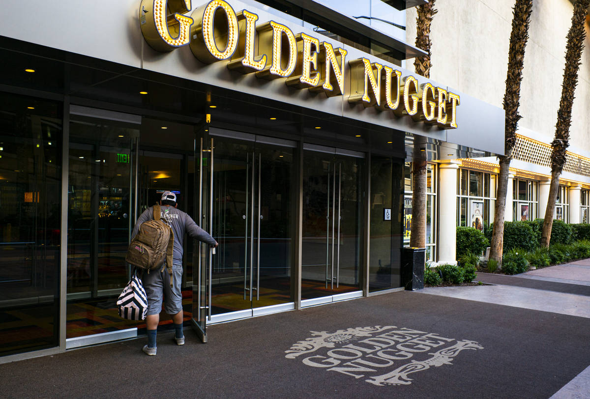 A man walks into the Golden Nugget as hotel-casinos reopen in downtown Las Vegas on Wednesday, ...