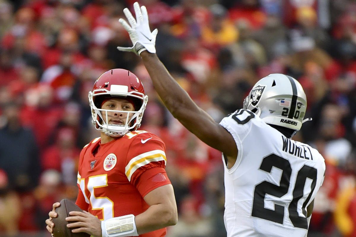 Kansas City Chiefs quarterback Patrick Mahomes (15) looks beyond Oakland Raiders cornerback Dar ...