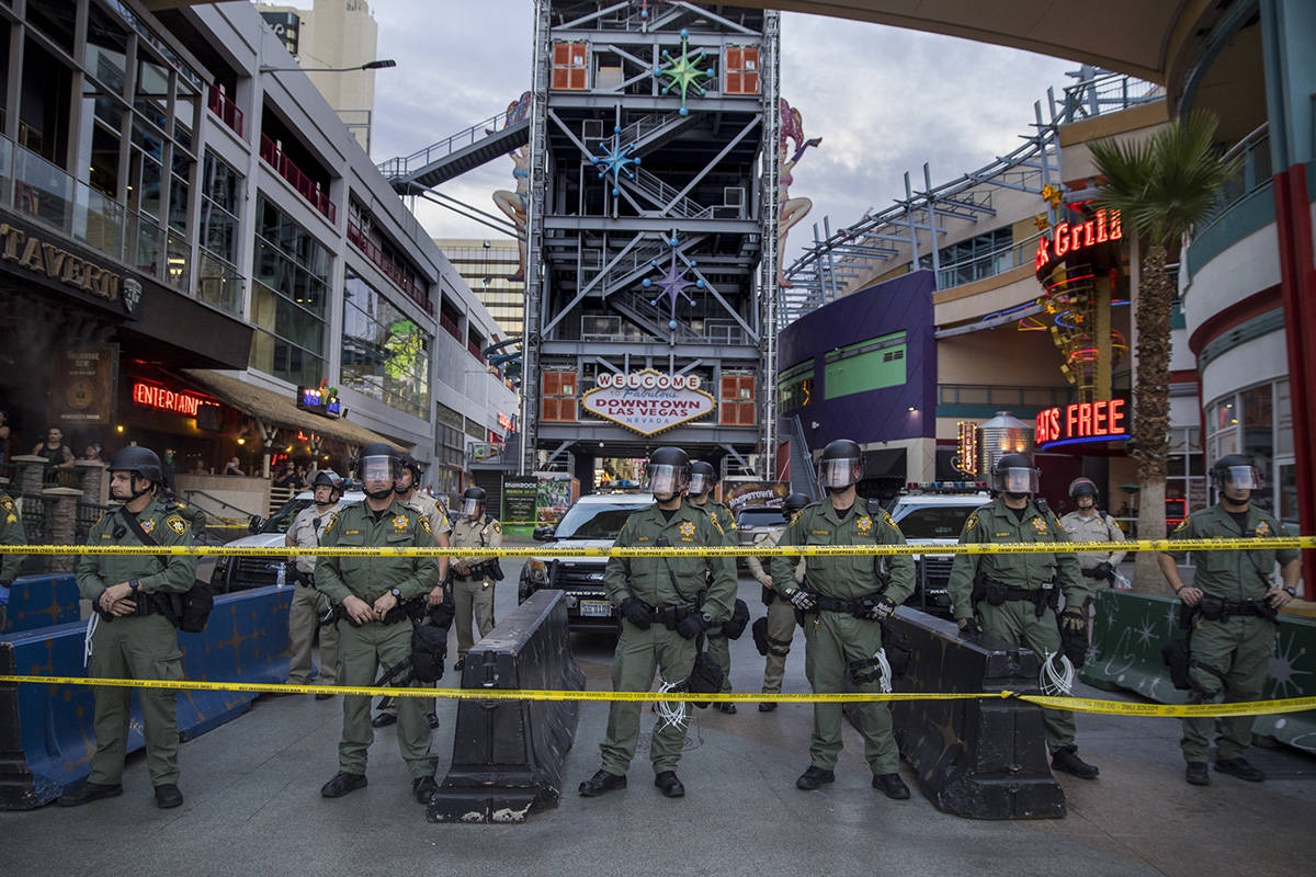 Police secure the Fremont Street Experience from protesters along Fremont Street during a Black ...