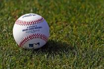 In this Feb. 17, 2017, file photo, a baseball is shown on the grass at the Cincinnati Reds base ...