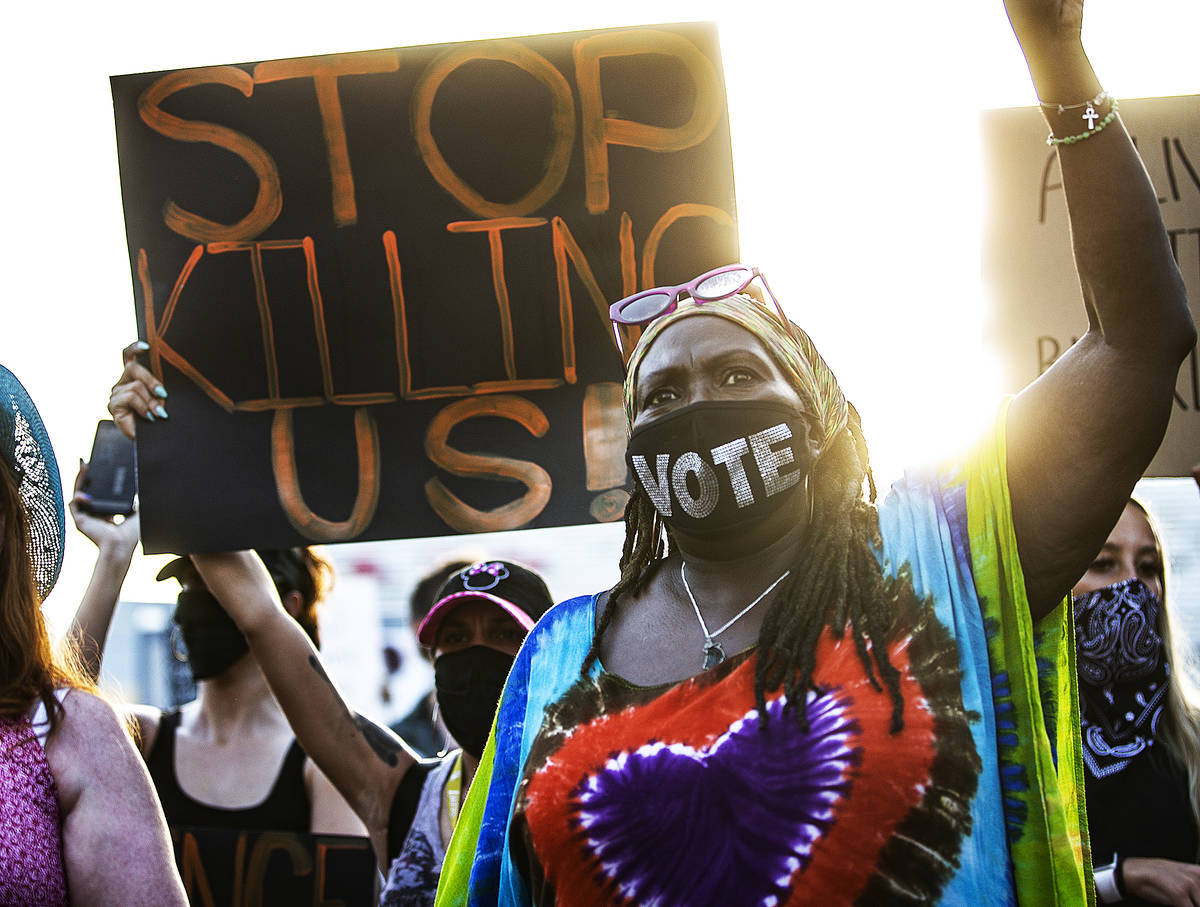 A crowd of at least 300 protesters march in downtown Las Vegas on Wednesday, June 3, 2020, as r ...