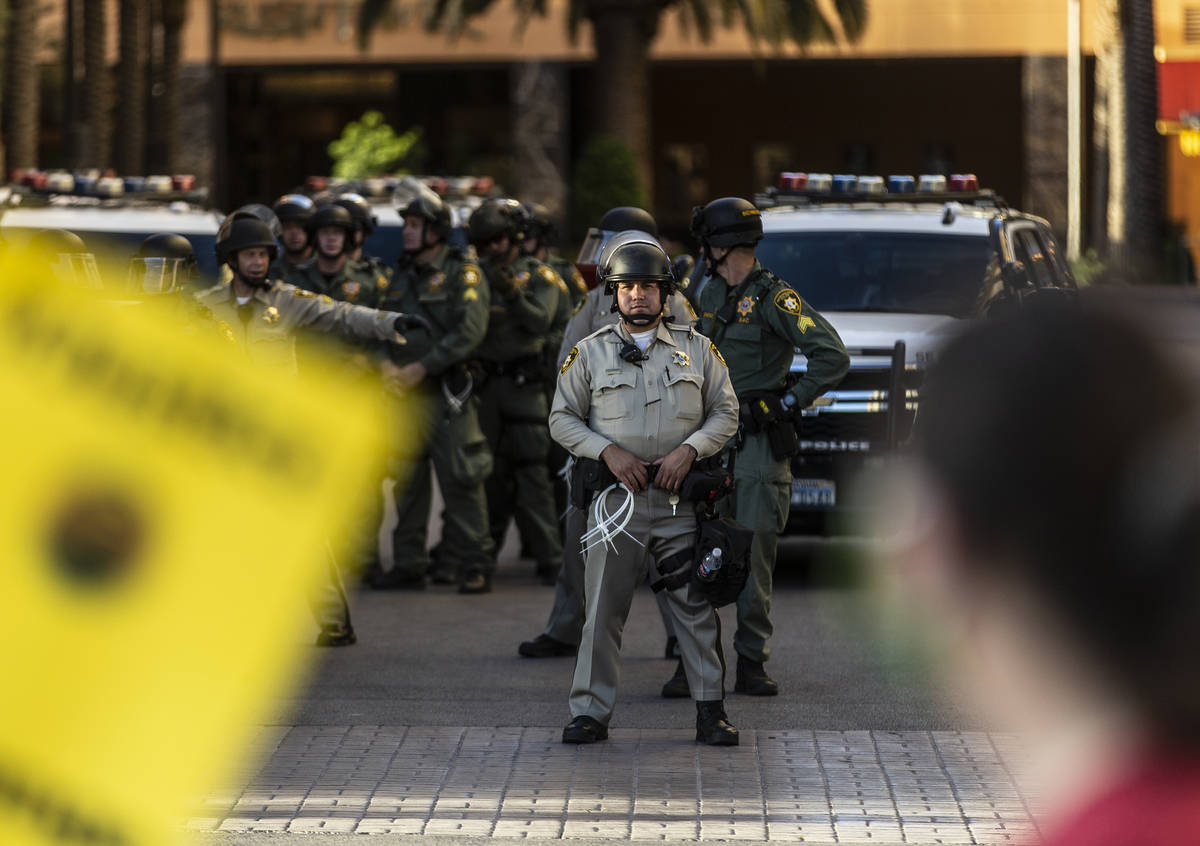 Las Vegas police officers watch protesters pass the Golden Nugget on Wednesday, June 3, 2020, i ...