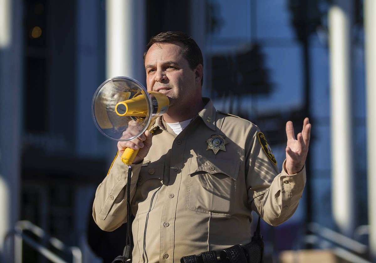Assistant sheriff Christopher Jones addresses a crowd of at least 300 protesters outside Las Ve ...