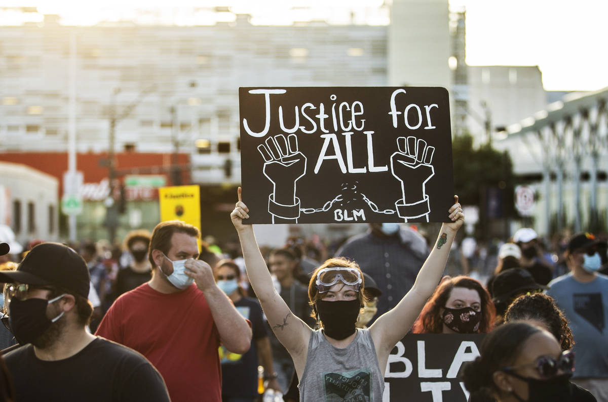A crowd of at least 300 protesters march in downtown Las Vegas on Wednesday, June 3, 2020, as r ...