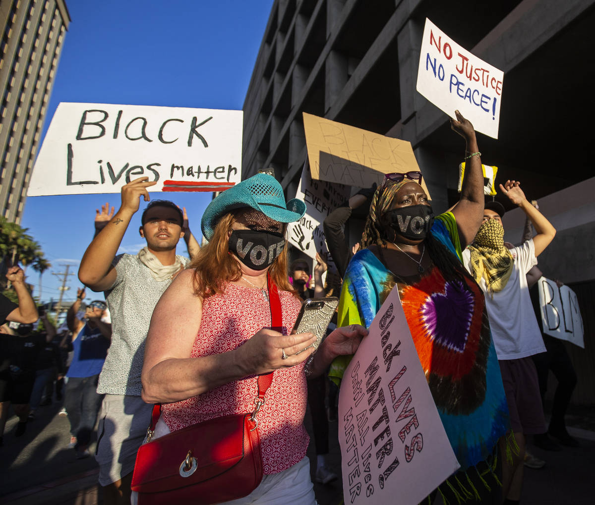 A crowd of at least 300 protesters march in downtown Las Vegas on Wednesday, June 3, 2020, as r ...