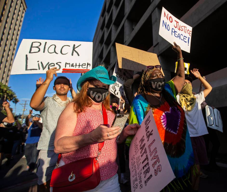 A crowd of at least 300 protesters march in downtown Las Vegas on Wednesday, June 3, 2020, as p ...