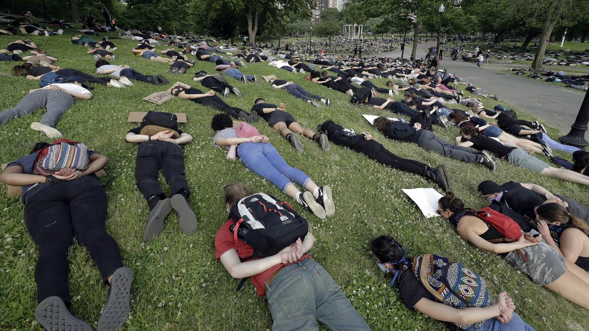 Demonstrators lie face down depicting George Floyd during his detention by police during a prot ...