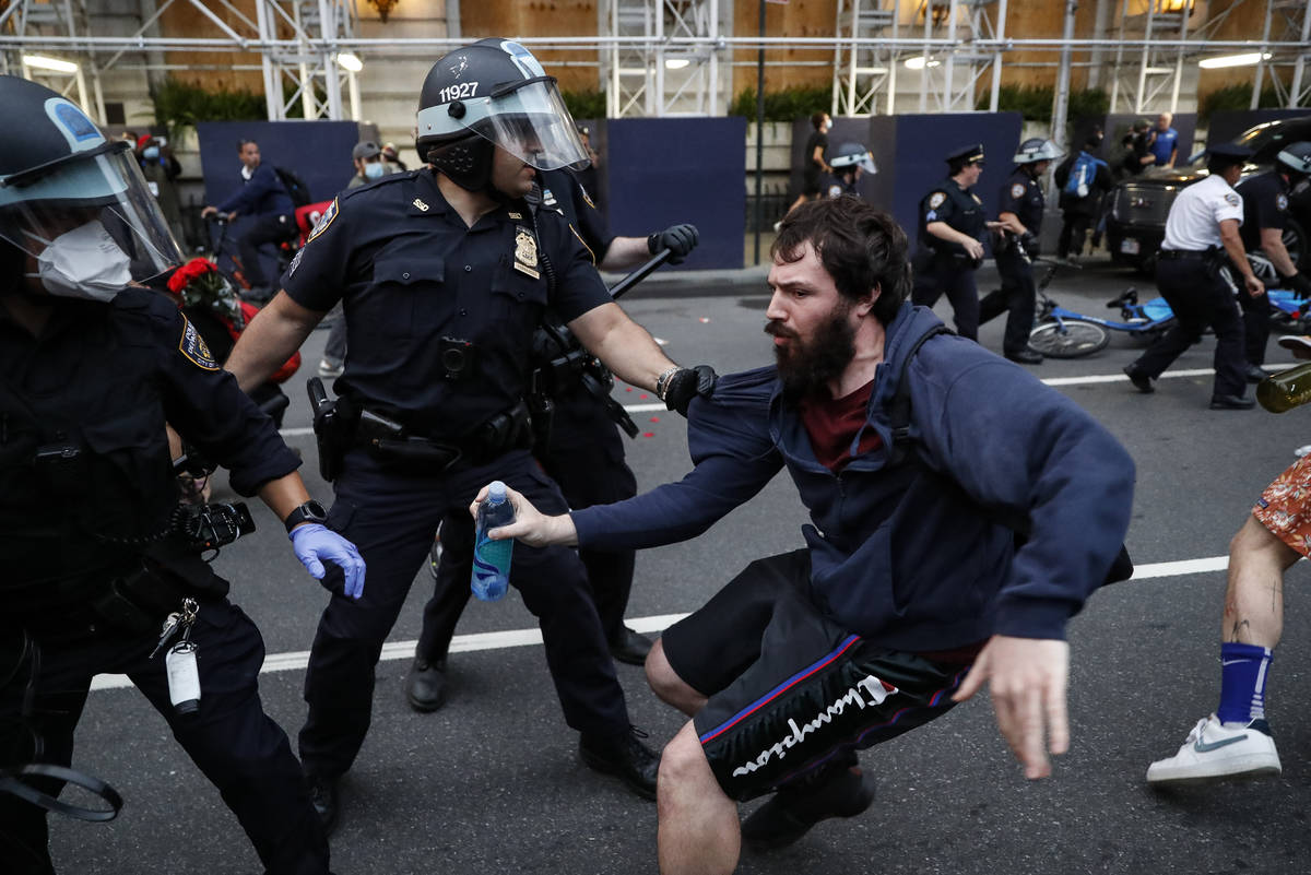 A protester is arrested for violating curfew near the Plaza Hotel on Wednesday, June 3, 2020, i ...