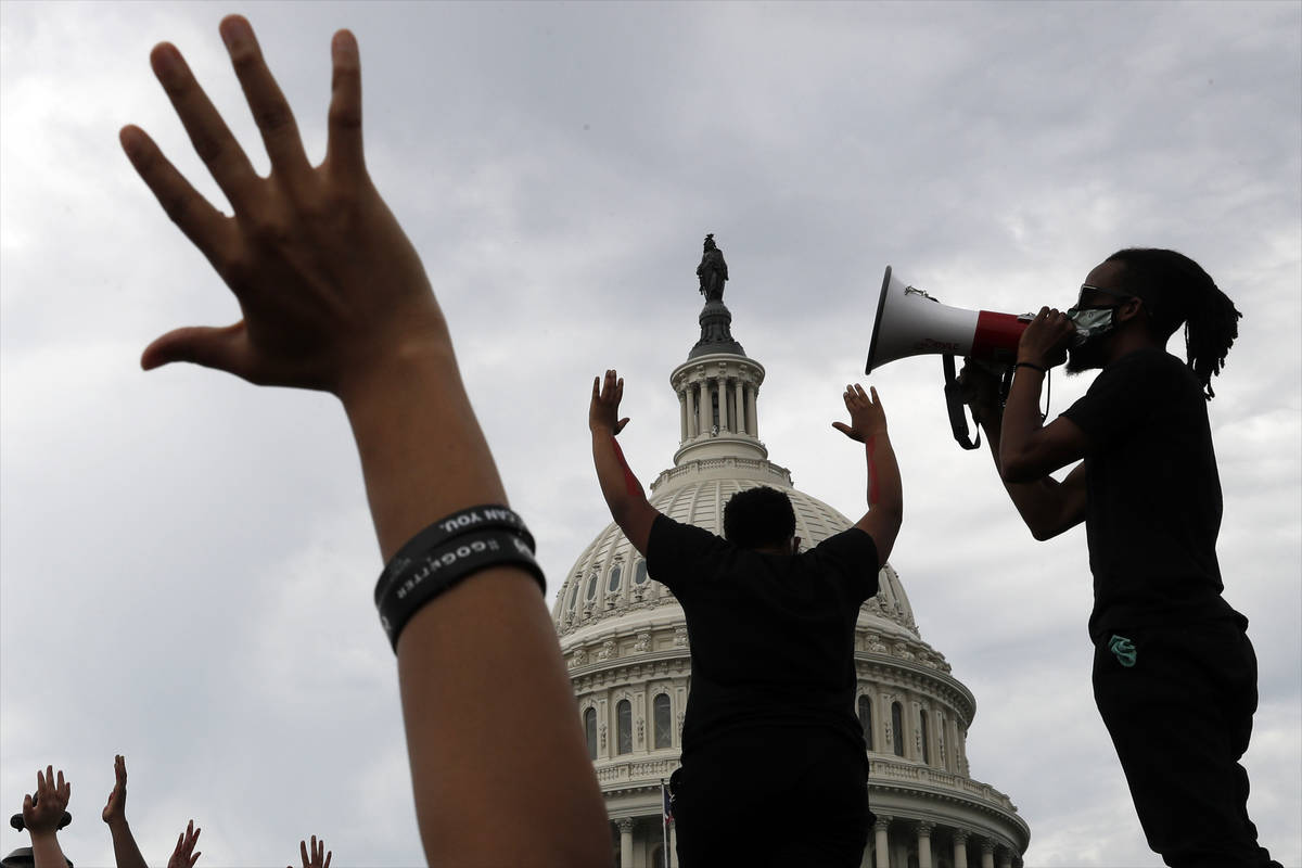 Demonstrators protest the death of George Floyd as they gather Wednesday, June 3, 2020, on the ...