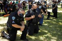 Fairfield police officers kneel during "Taking a knee for Justice and Prayer" service ...