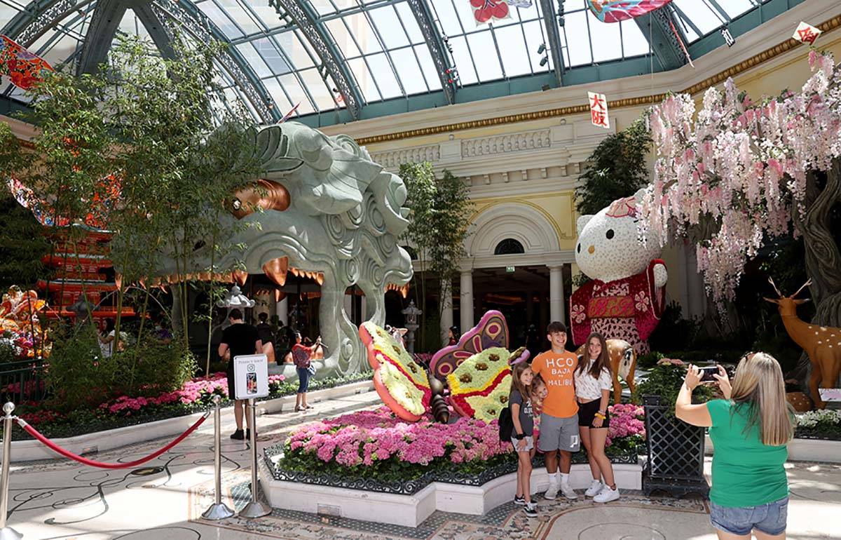 Chrissy Flasher of Las Vegas takes a photo of her children, from left, Victoria, 10, Tatiana, 3 ...