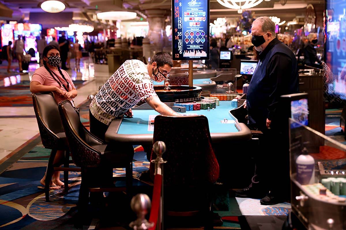 Guests play roulette at the Bellagio on the Strip in Las Vegas as the resort reopens after 78 d ...