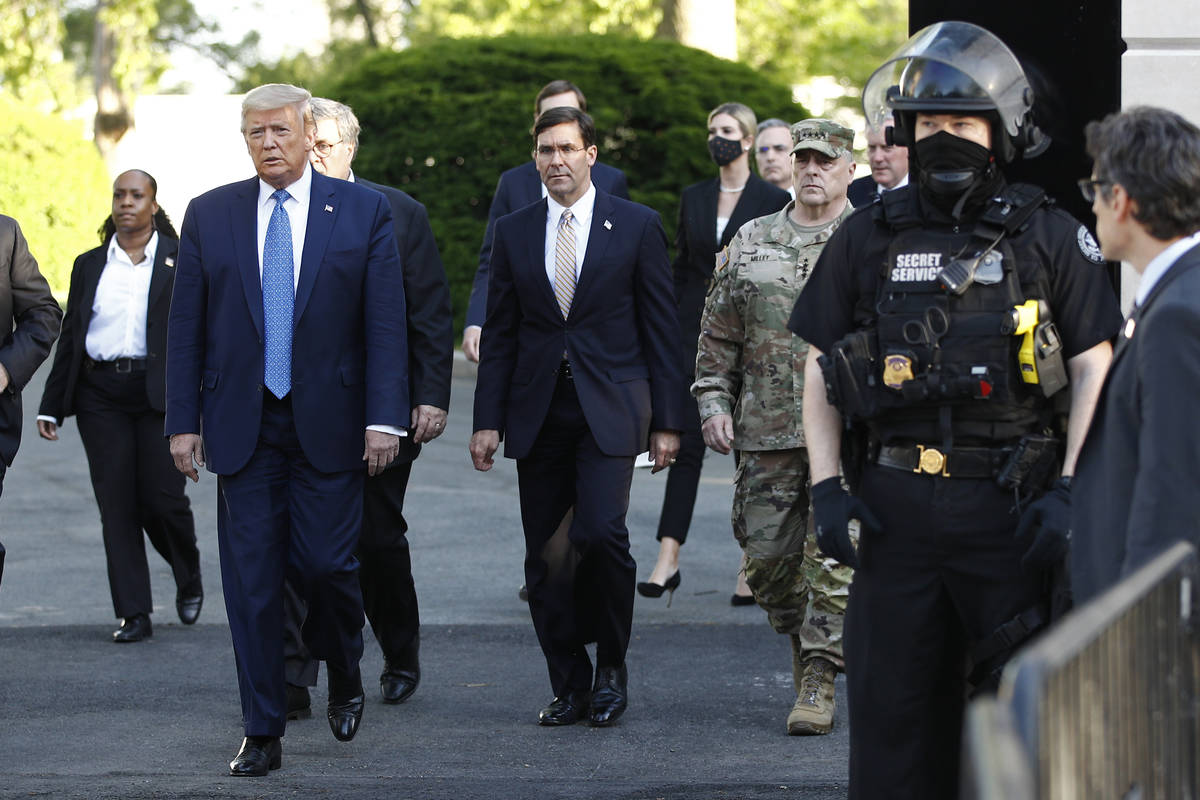 President Donald Trump departs the White House, accompanied by Secretary of Defense Mike Esper, ...