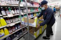 In a Wednesday, June 3, 2020 photo, Juan Santos stocks shelves at the Presidente Supermarket in ...