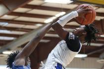 Las Vegas Knicks' Keshon Gilbert (3), right, takes a shot under pressure from U.T.U. Gorillas' ...