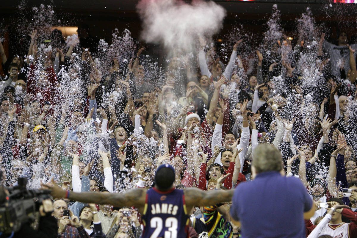 In this Dec. 25, 2008, file photo, fans toss confetti to mimic Cleveland Cavaliers' LeBron Jame ...